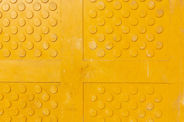 A top down view of yellow truncated domes, as a background.