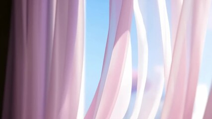 Pink sheer fabric flowing in the air with soft blue sky - Powered by Adobe