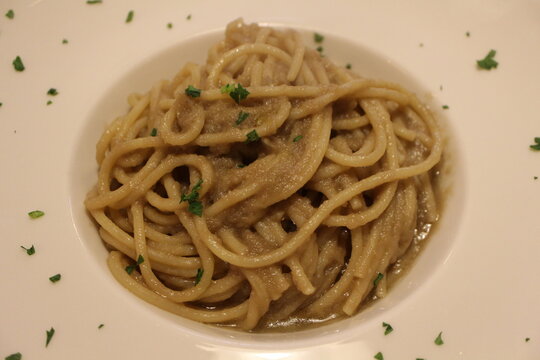 Italian cuisine: bigoli in salsa (bigoli basta with anchovies and onions) in Venice, Italy