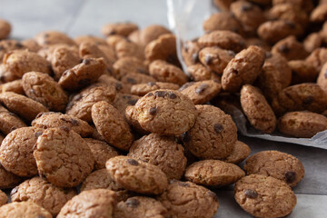 A view of a pile of chocolate cookie cereal, spilling out of the package.