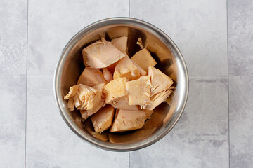 A top down view of a metal bowl of canned young jackfruit.