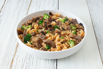 A view of a steak pasta entree, featuring gluten-free cascatelli pasta.
