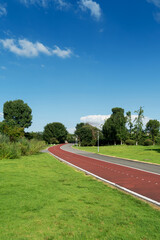 New pathway and beautiful trees track for running or walking and cycling relax in the park