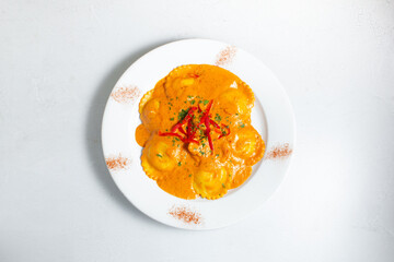 A top down view of a plate of lobster ravioli.