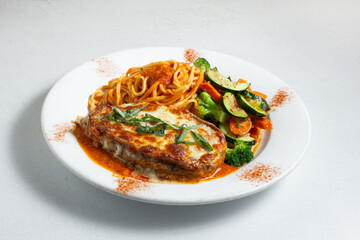 A view of a plate of eggplant parmesan.