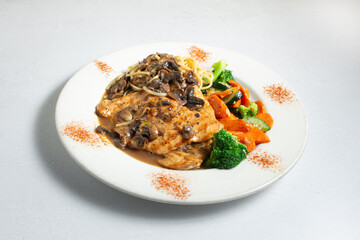 A view of a plate of chicken marsala.