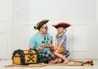 Father and his daughter dressed as pirates sharing a fun moment