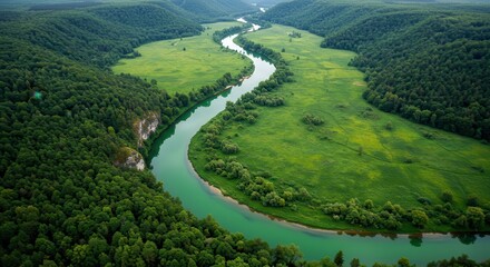 Serpentine river winding through lush green terrain
