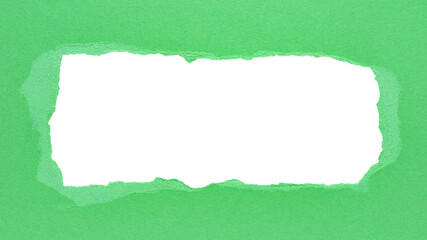 Green torn paper or cardboard message backdrop with rough edges and blank copy space for text in...