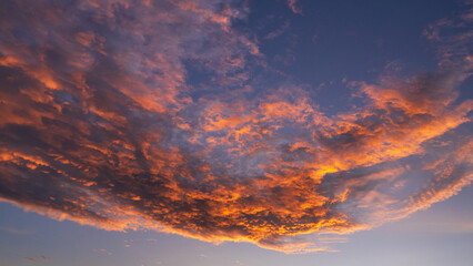 Abstract gorgeous orange sunset colorful clouds in evening sky, Nature background.