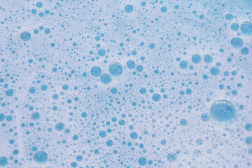 Blue water with white foam bubbles