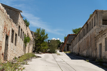 Exploring the abandoned remains of a historical site in Croatia under a bright blue sky