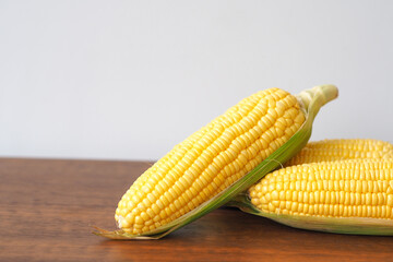 Fresh corn on wooden table background