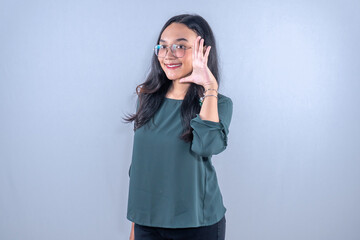 Fototapeta premium Indonesian Asian woman wearing blue clothes smiling and wanting to tell