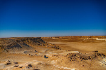 Sinai desert. Yellow and orange sandstone textured carved mountain, bright blue sky. Egyptian...