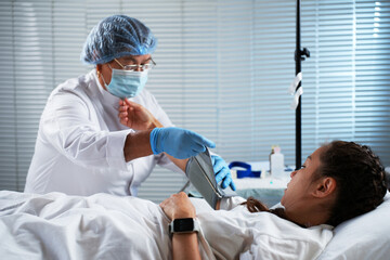 Nurse Taking Patient's Blood Pressure in a Hospital Room