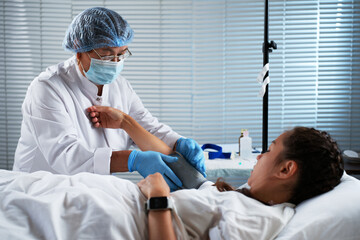 Nurse Taking Patient's Blood Pressure in a Hospital Room