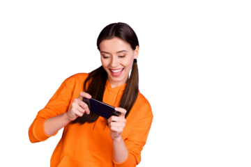 Portrait of addicted crazy funny funky teenager girl use her smartphone play game wear orange sportswear isolated over violet purple color background