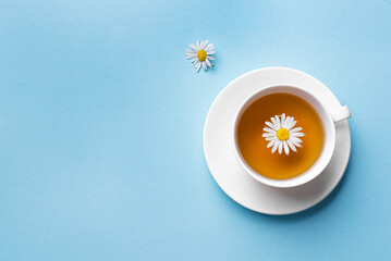 Chamomile tea cup on blue background