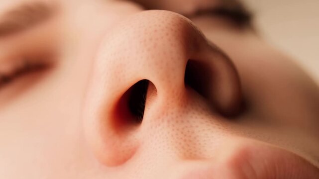 Serene close up montage revealing multiple frames of woman's nose during deep breathing, highlighting peaceful respiratory process with closed eyes and natural skincare details