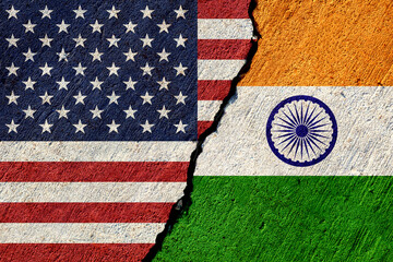 usa and india flags painted on cracked concrete wall