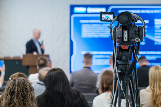 Event showcasing speaker delivering presentation to audience, recorded with professional video equipment. - Powered by Adobe