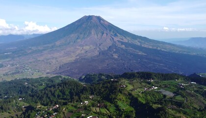 Fototapeta premium Volcano overlooking a valley with lush greenery.