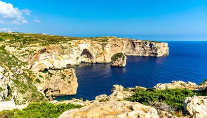 Coastal landscape with dramatic limestone formations and turquoise waters.