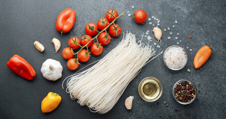 Noodles Tomatoes Garlic And Yellow Pepper On Black Background