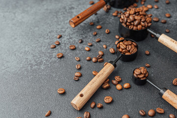 Three measuring spoons filled with coffee beans flat lay