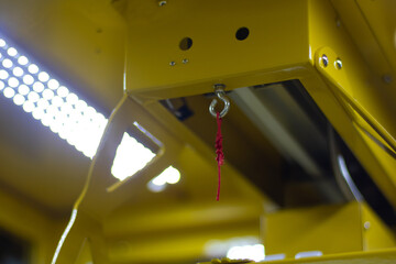 Yellow industrial machine with safety pull cord