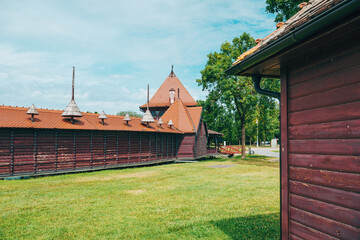 Traditional wooden boathouse with ornate details on Lake Palic, Serbia, extending over calm green...