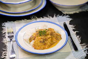 Typical Czech cuisine pork slice on mushrooms with rice