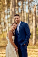 Fototapeta premium Elegant Couple Posing in Nature During a Pleasant Autumn Afternoon