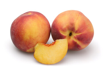 Two ripe peaches and a slice isolated on white background.
