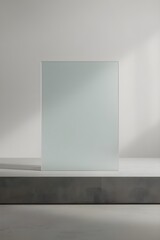 Rectangular frosted glass slab positioned on matte grey stone surface