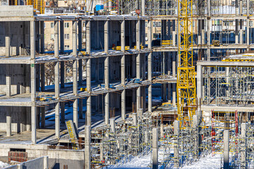 Tall building under construction with scaffolds,Freestanding tower crane on a building...