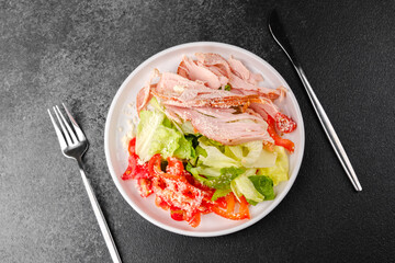 Healthy turkey and vegetable salad in white bowl for diet or fitness meal concept