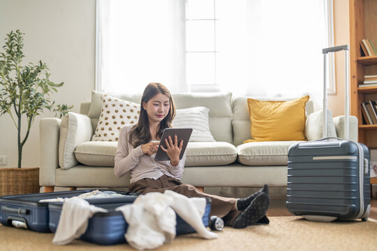 Portrait of woman use technology of tablet computer for hotel and resort booking online summer holiday travel system planning searching information weekend vacation trip.reservation online travel - Powered by Adobe
