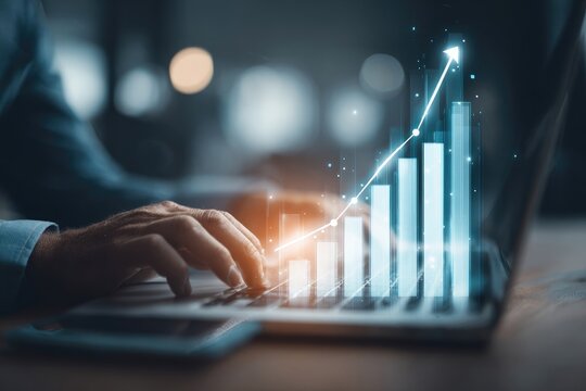 Close-up of person working on laptop with increasing bar graph overlay