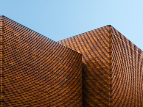 Brick building wall Brown texture Architecture exterior facade with blue sky