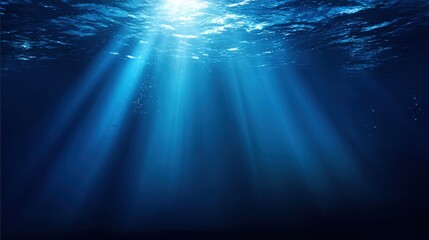 Obraz premium Underwater Scene with Sunbeams Illuminating the Deep Blue Sea, Creating a Serene and Tranquil Atmosphere