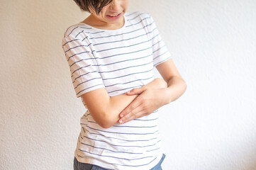 Teen holding sore elbow, hand supporting injured arm, Portrait Teenager, youth, sports injury,...