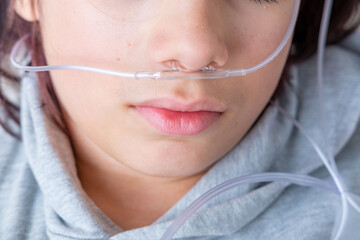 teenager male Patient with oxygen nasal cannula, respiratory support therapy, breathing assistance...