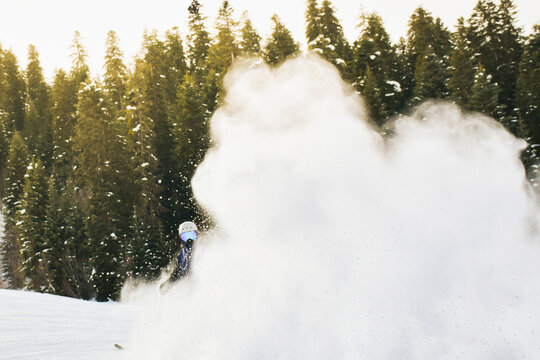 Close up banner experienced male skier on piste ski downhill carving fast motion in Alps. Active winter holidays, skiing downhill in sunny day in alps. Ski rides on the track with swirls