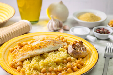 grilled cod with couscous, chicken pea and baked garlic