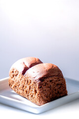 chocolate flavoured bread. Two chocolate loaves on a white plate
