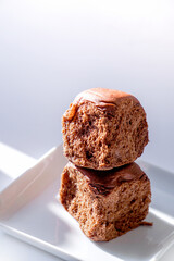 chocolate flavoured bread. Two chocolate loaves on a white plate
