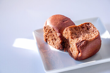 chocolate flavoured bread. Two chocolate loaves on a white plate