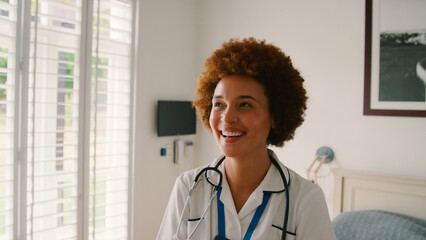 Portrait Of Smiling Female Nurse Wearing Uniform With Digital Tablet In Private Hospital Room